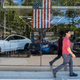 A person walks by a car dealership on June 10, 2022 in New York City. The Labor Department announced on Monday that consumer prices rose 8.6% last month from a year earlier. Inflation has risen to its highest level in four decades, raising the cost of airfare, hotels, vehicles, gas, and food.